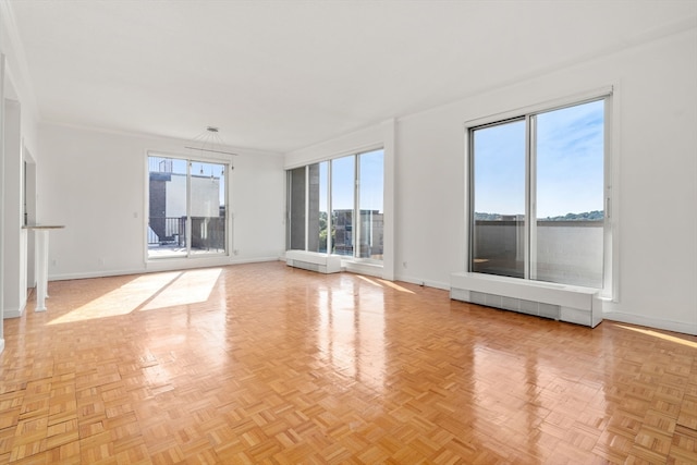 spare room with radiator and light parquet flooring