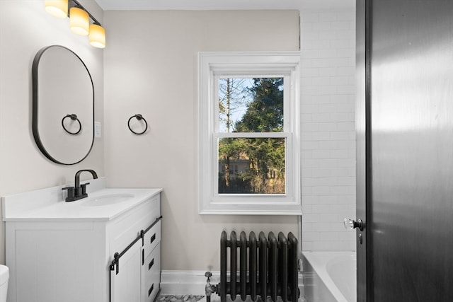 bathroom with a bathing tub, radiator heating unit, vanity, and toilet