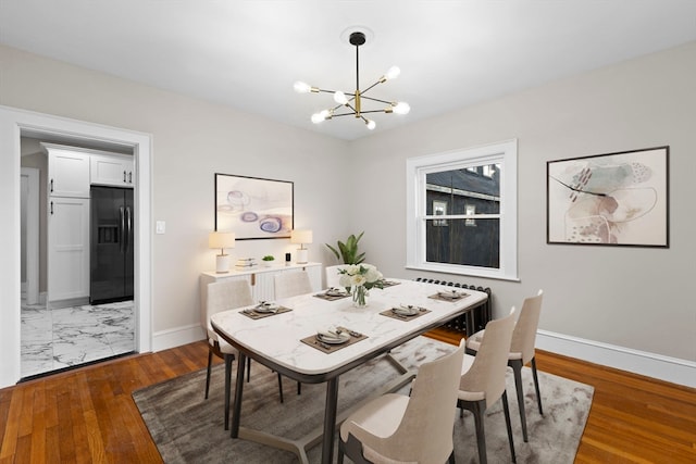 dining space with an inviting chandelier and dark wood-type flooring