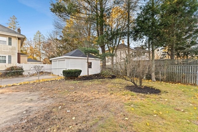 view of yard featuring a garage and an outdoor structure