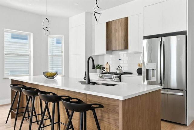 34 Woodford St Unit 2, Boston, MA 02125 - kitchen featuring stainless steel appliances, modern cabinets, white cabinets, and a kitchen island with sink