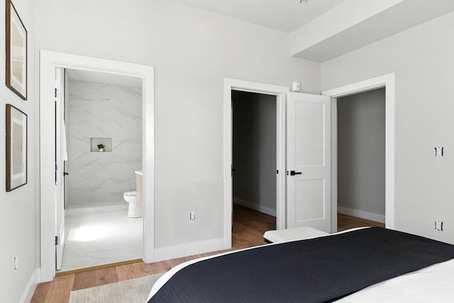 34 Woodford St Unit 2, Boston, MA 02125 - bedroom featuring wood finished floors, a walk in closet, connected bathroom, and a closet