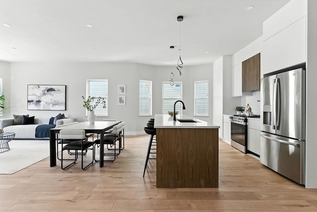 34 Woodford St Unit 2, Boston, MA 02125 - kitchen featuring appliances with stainless steel finishes, modern cabinets, a breakfast bar area, a center island with sink, and healthy amount of natural light