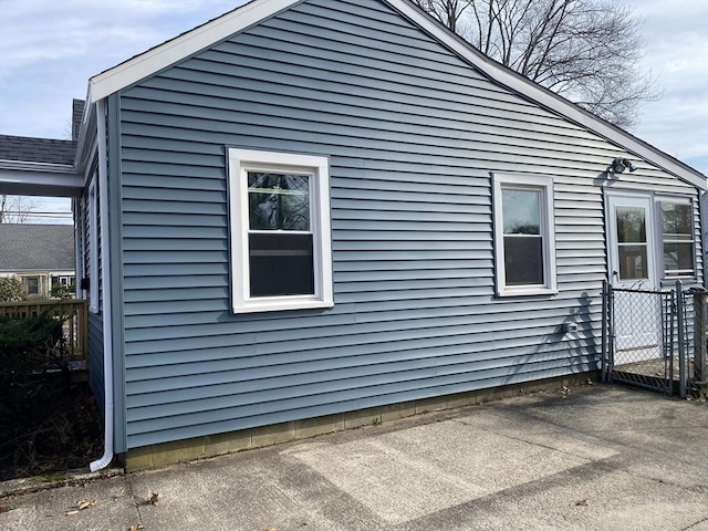 view of home's exterior with fence