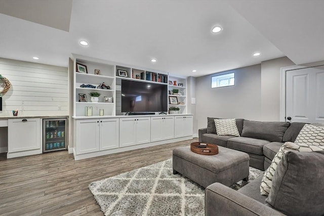 living room with light hardwood / wood-style flooring, indoor bar, and wine cooler