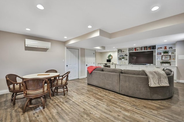 living room featuring light hardwood / wood-style floors and a wall mounted air conditioner