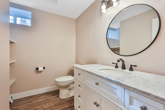 bathroom featuring toilet, vanity, and hardwood / wood-style flooring