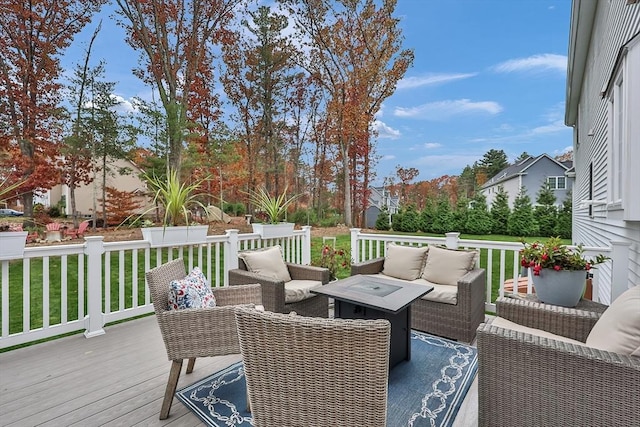 wooden terrace with an outdoor hangout area and a lawn