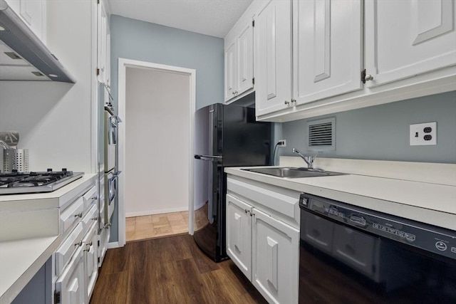 kitchen featuring black appliances, dark hardwood / wood-style floors, white cabinets, and sink