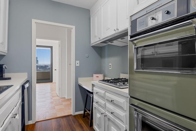 kitchen with dark hardwood / wood-style floors, white cabinetry, and appliances with stainless steel finishes