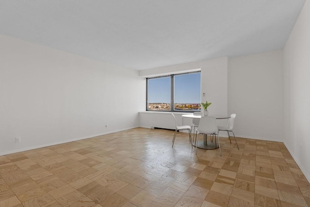 unfurnished room featuring light parquet flooring