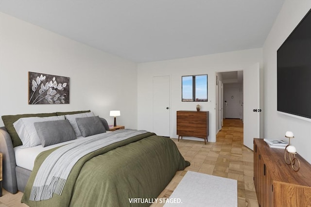 bedroom with light parquet flooring