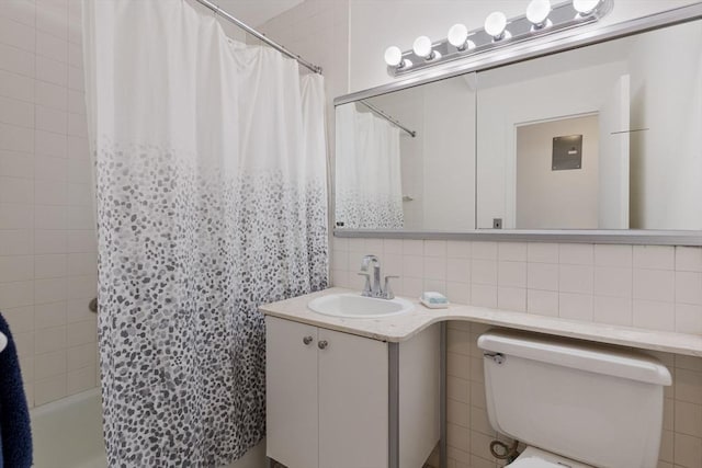 full bathroom with backsplash, toilet, shower / tub combo with curtain, vanity, and tile walls