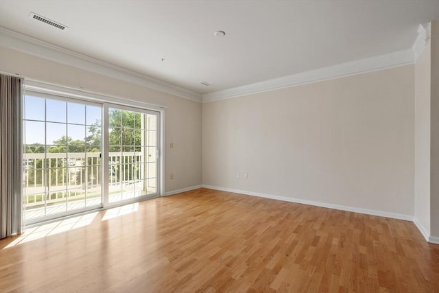 unfurnished room with light wood-type flooring and crown molding