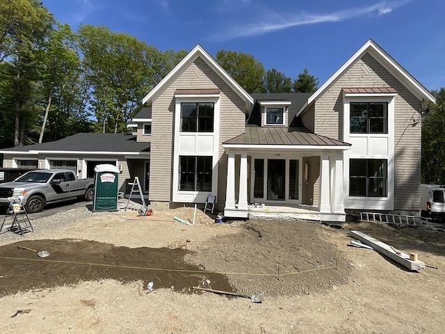 1780 Central Ave, Needham, MA 02492 - view of front of home featuring a standing seam roof, an attached garage, metal roof, a porch, and driveway