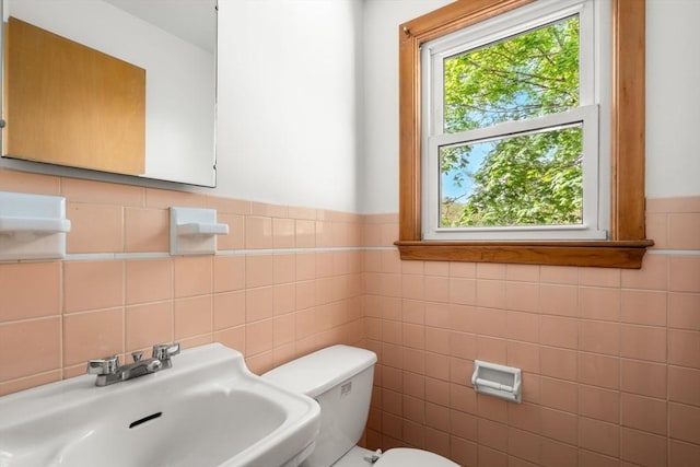 35 Bemis St, Weston, MA 02493 - bathroom with a sink, tile walls, toilet, and wainscoting
