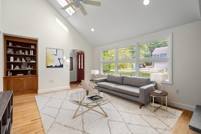 35 Bemis St, Weston, MA 02493 - living area featuring arched walkways, high vaulted ceiling, plenty of natural light, light wood-style flooring, and a ceiling fan