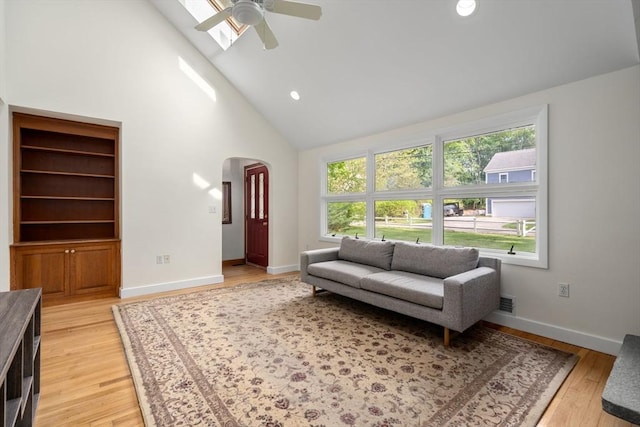 35 Bemis St, Weston, MA 02493 - living room with arched walkways, high vaulted ceiling, a ceiling fan, light wood-type flooring, and baseboards