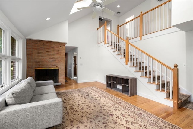 35 Bemis St, Weston, MA 02493 - living area featuring stairs, wood finished floors, ceiling fan, high vaulted ceiling, and baseboards
