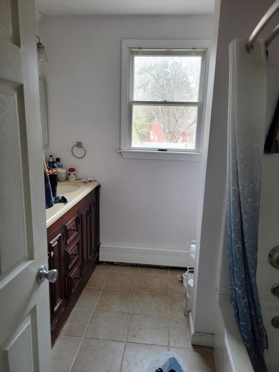 bathroom with shower / bath combo, tile patterned flooring, and vanity