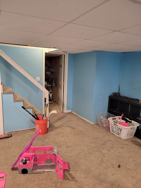 game room featuring carpet and a drop ceiling