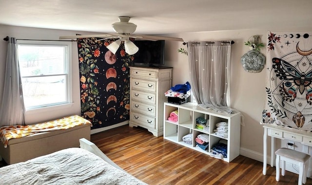 bedroom featuring baseboards and wood finished floors