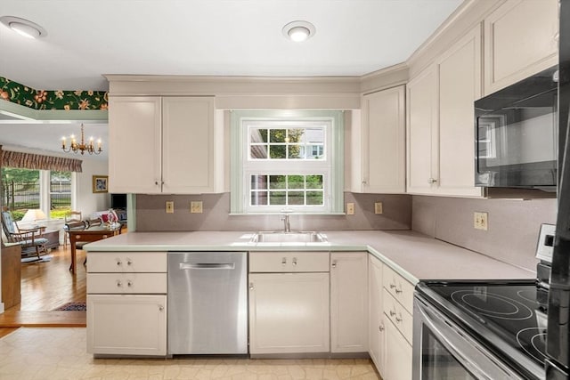 52 Harding Rd, Lexington, MA 02420 - kitchen with appliances with stainless steel finishes, a sink, healthy amount of natural light, and a chandelier
