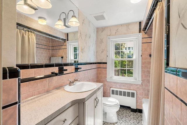 52 Harding Rd, Lexington, MA 02420 - full bathroom featuring radiator, tile walls, vanity, toilet, and shower / tub combo