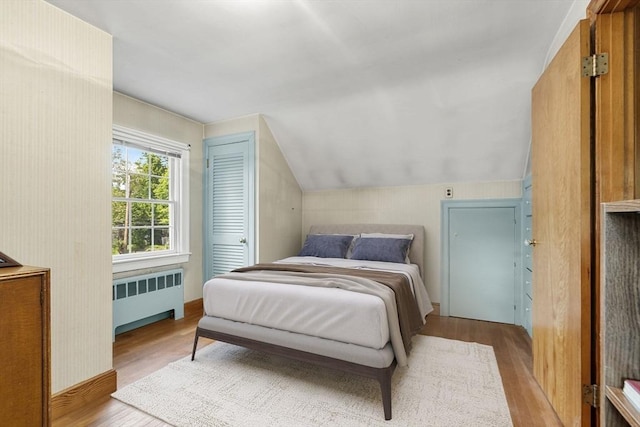 52 Harding Rd, Lexington, MA 02420 - bedroom with radiator, wood finished floors, and vaulted ceiling