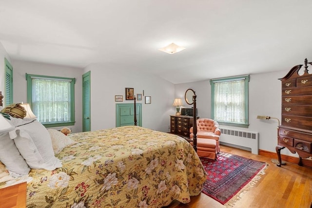 52 Harding Rd, Lexington, MA 02420 - bedroom featuring radiator heating unit, multiple windows, wood finished floors, and baseboards