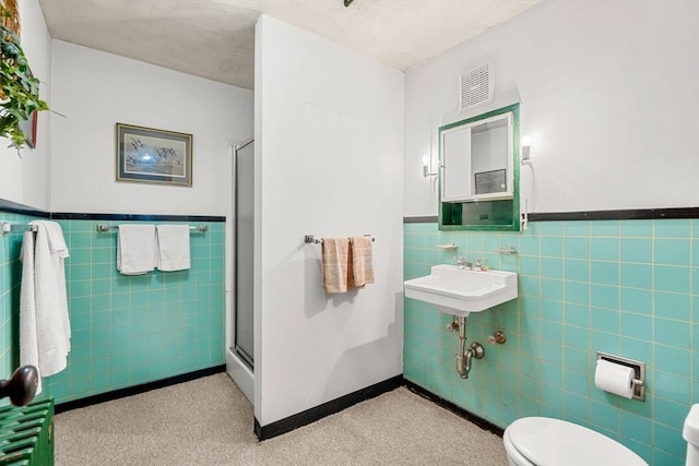 52 Harding Rd, Lexington, MA 02420 - full bath with tile walls, a stall shower, wainscoting, toilet, and a sink