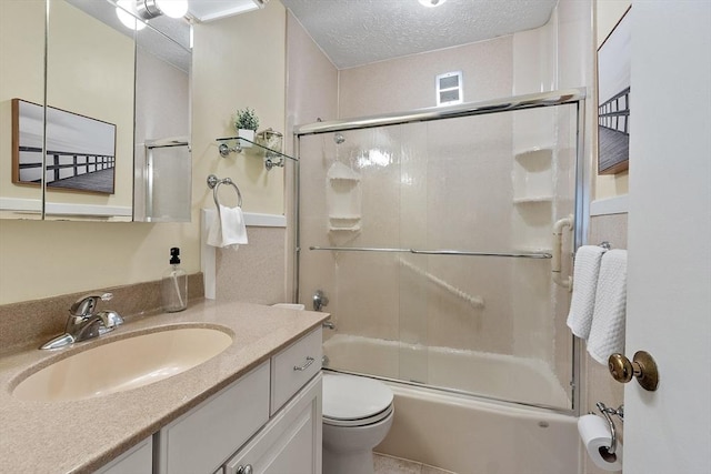 full bath featuring bath / shower combo with glass door, toilet, vanity, and a textured ceiling