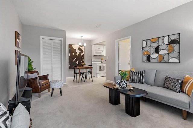 living area with light carpet, a chandelier, and baseboards