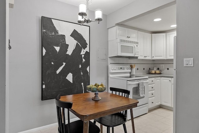 dining space with a chandelier, recessed lighting, and light tile patterned flooring