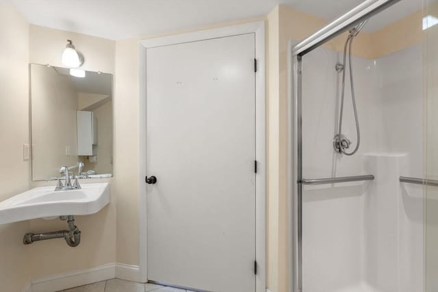 bathroom with sink, tile patterned flooring, and a shower with door