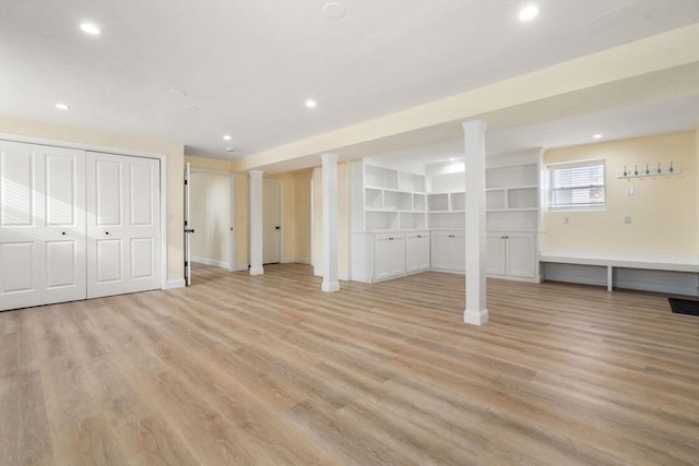 basement with light hardwood / wood-style flooring