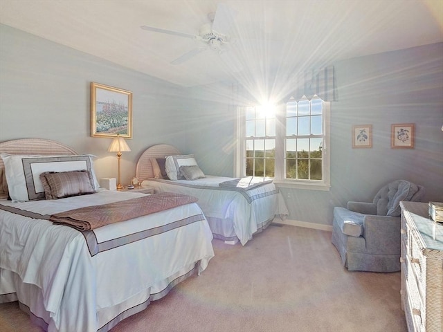 bedroom featuring ceiling fan and light carpet