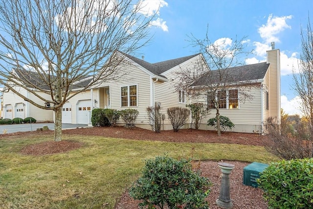 view of front of property featuring a garage and a front lawn