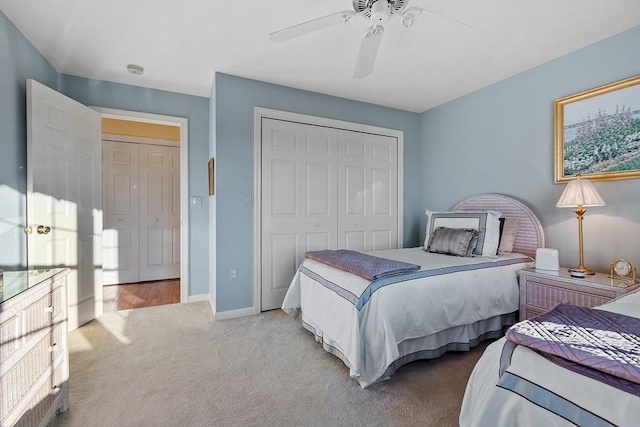 bedroom with carpet, ceiling fan, and a closet