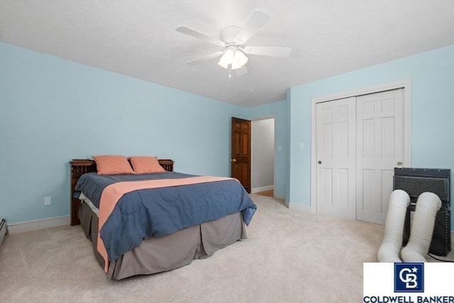 bedroom with a closet, carpet, and baseboards