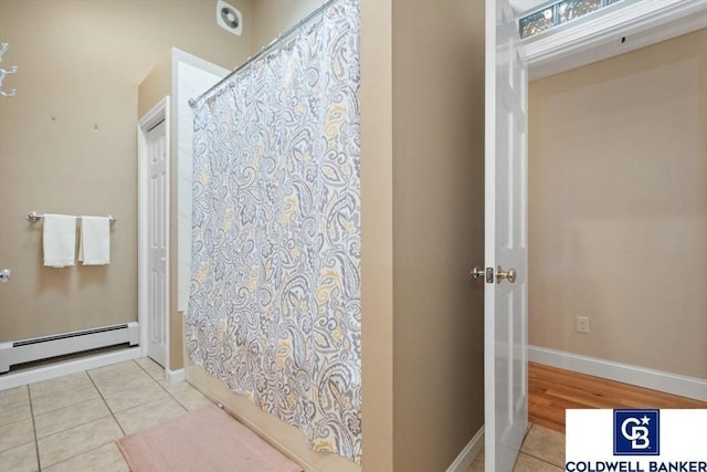 full bath featuring tile patterned flooring, a shower with curtain, baseboards, and baseboard heating