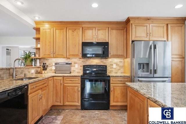 kitchen with a sink, open shelves, black appliances, and light stone countertops