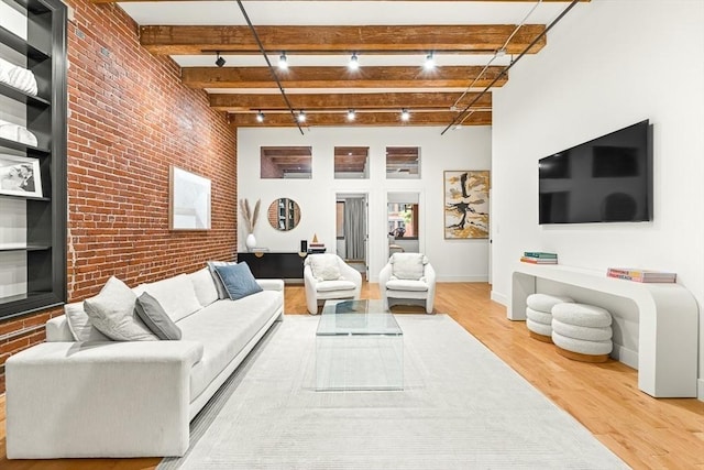 33 Sleeper St Unit 106, Boston, MA 02210 - living room featuring brick wall, wood finished floors, and beam ceiling