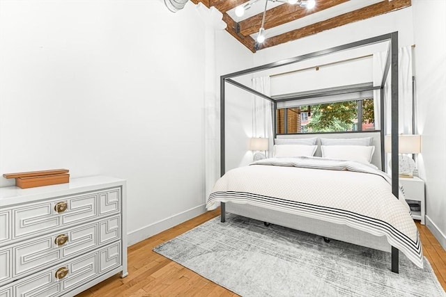 33 Sleeper St Unit 106, Boston, MA 02210 - bedroom with light wood-type flooring and beamed ceiling