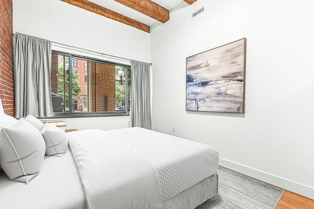 33 Sleeper St Unit 106, Boston, MA 02210 - bedroom with wood finished floors and beam ceiling