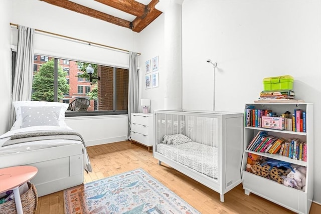 33 Sleeper St Unit 106, Boston, MA 02210 - living area featuring wood finished floors and beam ceiling