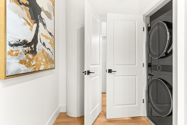 33 Sleeper St Unit 106, Boston, MA 02210 - washroom featuring estacked washer and dryer and light wood-style flooring