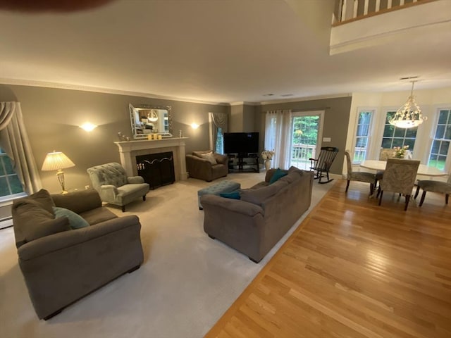 52 Cranberry Rd, Hanson, MA 02341 - living area featuring light wood finished floors, a chandelier, ornamental molding, and a fireplace