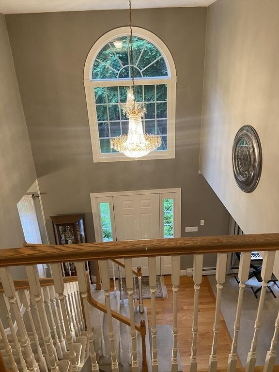 52 Cranberry Rd, Hanson, MA 02341 - entrance foyer with a high ceiling, a chandelier, plenty of natural light, wood finished floors, and stairs