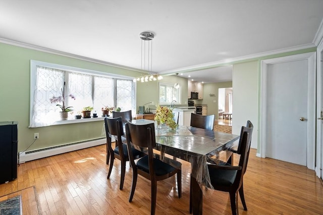 5 Northgate Rd, Chelmsford, MA 01824 - dining area featuring a baseboard heating unit, ornamental molding, and light wood-style flooring